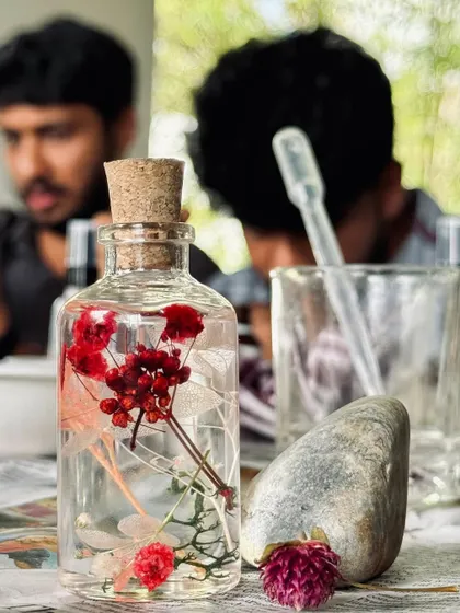 A close-up of a herbarium jar being created. These hands-on creative sessions are a regular part of our studio life, fostering teamwork and a connection to craft.