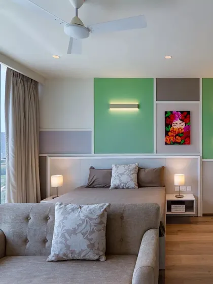 A bedroom from the Conscient One project, showcasing a playful use of color blocking and art.