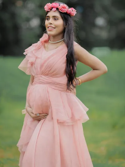 A close-up shot capturing the happy expression and glowing look of this mom-to-be, complemented by a floral crown.
