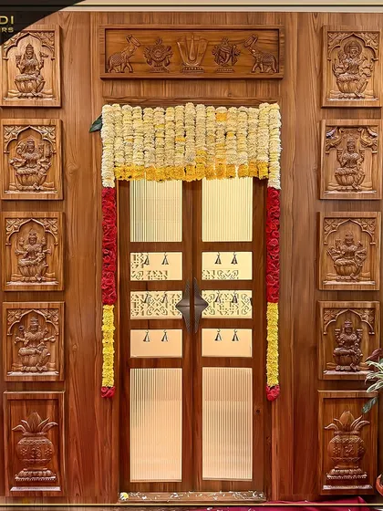 An example of my dedication to traditional craftsmanship, this magnificent wooden puja room door is adorned with intricate carvings of deities. The design is complemented by festive marigold garlands, creating a truly sacred and welcoming entrance.