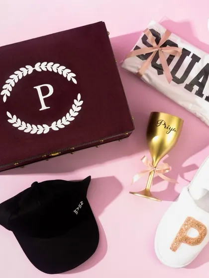 A curated hamper for the "Groom's women," because the groom's squad isn't always just guys. This box includes a personalized cap, slippers, and a custom wine glass.