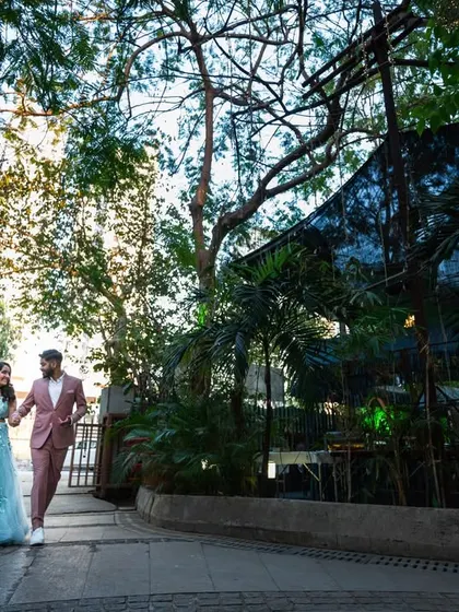 A wide shot of the couple walking, showing off their outfits and the location. This helps to set the scene for their story.