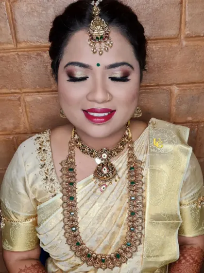 A classic bridal makeover with a focus on shimmering gold eyes and a bright red lip, perfect for a traditional ceremony.