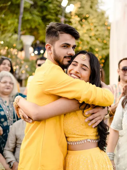 A warm hug between siblings or close friends during the Haldi ceremony, a moment of love and support amidst the festivities.
