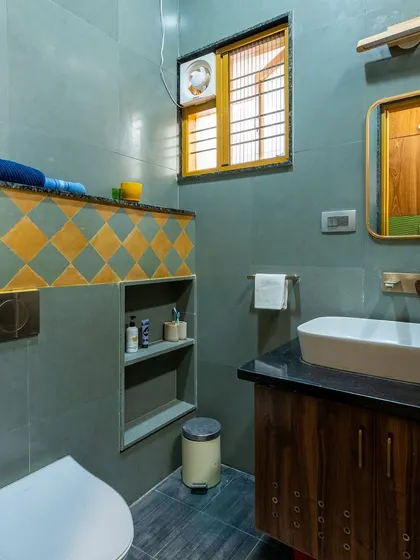 A well-designed bathroom with thoughtful details like a built-in niche and coordinated fixtures.
