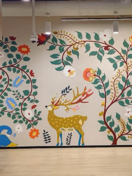 For the Databricks India office, we blended technology with tradition. This mural uses classic Indian art forms like Madhubani and Kalamkari to tell a modern story, featuring elephants and peacocks alongside corporate branding.