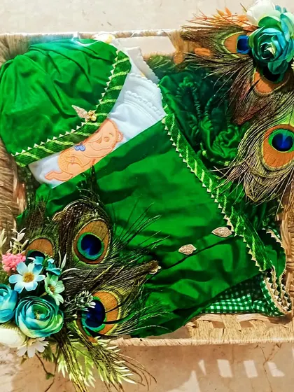 A unique packing idea using real peacock feathers for a green-themed gift basket.