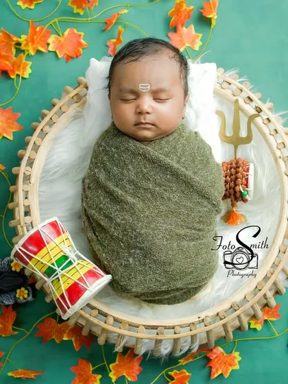 Another angle of the little Shiv, with the Damaru drum placed beside him. The green and orange color palette evokes a feeling of nature and divinity.