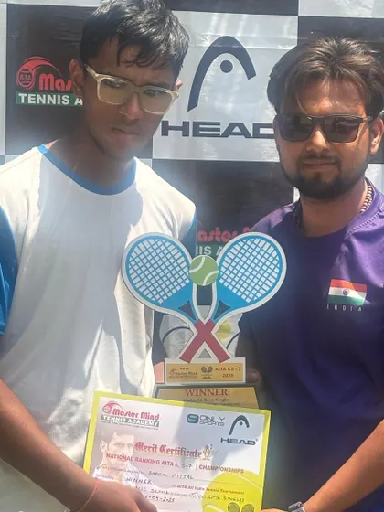 Posing with one of our national ranking AITA U-16 championship winners. This player is holding his winner's trophy and merit certificate, proof of his dedication.