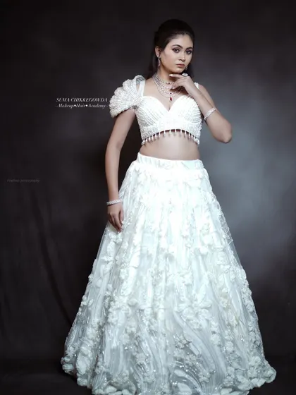An angelic look in a white lehenga, perfect for a reception. I created a soft, glowing makeup look with a subtle pink eyeshadow and a matching lip to give the bride a dreamy, ethereal feel.