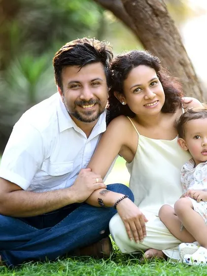 A classic family portrait in the park. Outdoor sessions are wonderful for capturing genuine smiles and relaxed interactions.