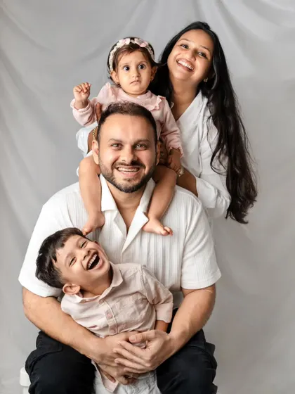 A fun and creative pose with the whole family stacked together for a portrait that is full of personality and laughter.