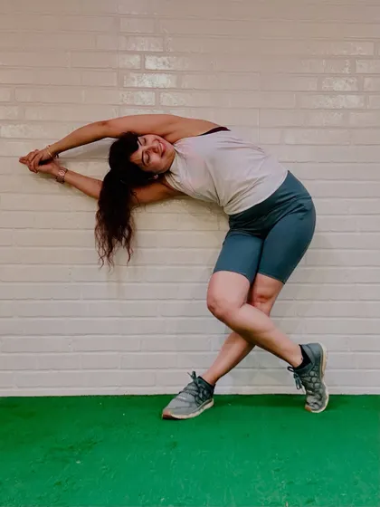 After a run, a mindful stretch is essential. Here, I am using the wall to support a deep side bend, releasing the muscles of my back and legs. This is how I integrate mindfulness into every form of movement, connecting the rush of cardio with the stillness of a stretch.