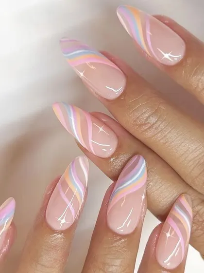 This elegant almond-shaped set features delicate pastel rainbow swirls on a sheer nude base. The glossy finish makes the colors pop, creating a subtle yet beautiful design.