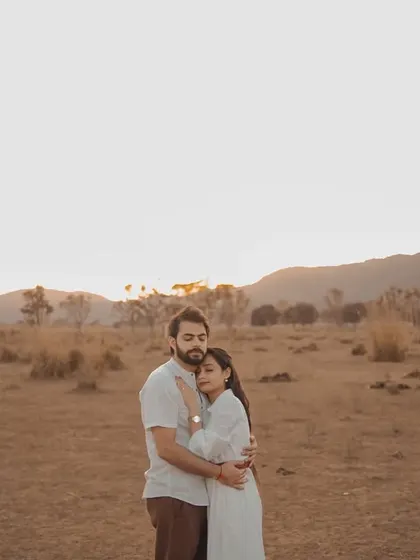 A tender embrace at sunset. The soft, warm light of the golden hour creates a romantic and intimate mood, perfect for capturing the quiet connection between a couple.