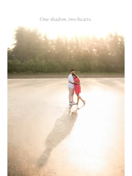 An artistic pre-wedding shot on the beach, where the couple's single shadow stretches across the sand, symbolizing their unity.