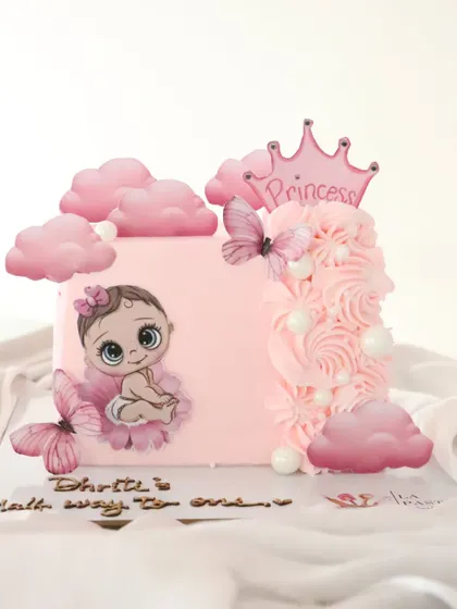 Another angle of the princess-themed half-birthday cake, showing the beautiful piping work and cloud details.