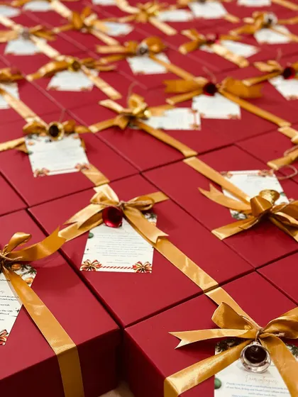 A sea of red and gold, these corporate gift boxes are prepared for dispatch, ensuring every recipient feels valued during the festive season.