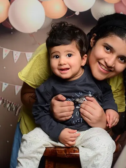 A sweet moment between two siblings in front of a pastel-themed backdrop in my studio.