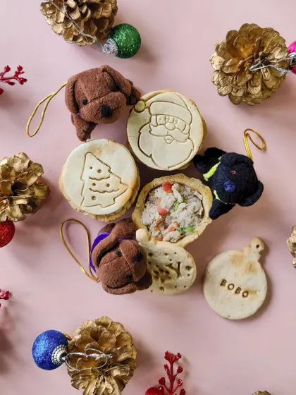 This shot shows my wholesome chicken pies, with one cut open to show the delicious filling inside. You can also see the personalized 'Bobo' name tag ornament and cute pupcharms.