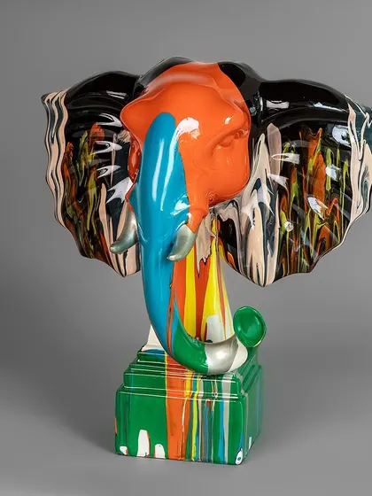 An abstract take on a majestic elephant head, this sculpture features a stunning mix of colors in a flowing, marbled pattern. It's a powerful and artistic piece that adds a touch of the exotic to your decor.