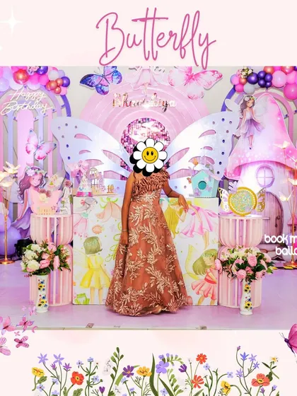 This butterfly theme was a vision in pink and purple. The birthday girl posed in front of the magical setup, which included a fairy house, whimsical props, and a sky filled with balloons and butterflies.