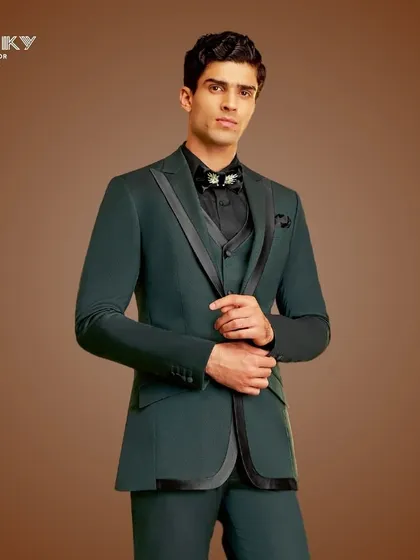 This dark teal tuxedo with black satin accents is tailored to perfection. It is an ideal choice for a grand reception, reflecting modern elegance and charm.