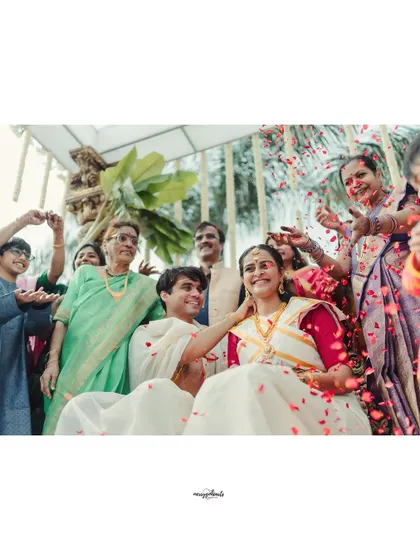 The whole family joins in to shower the couple with flowers and blessings. These are the moments that become cherished memories.