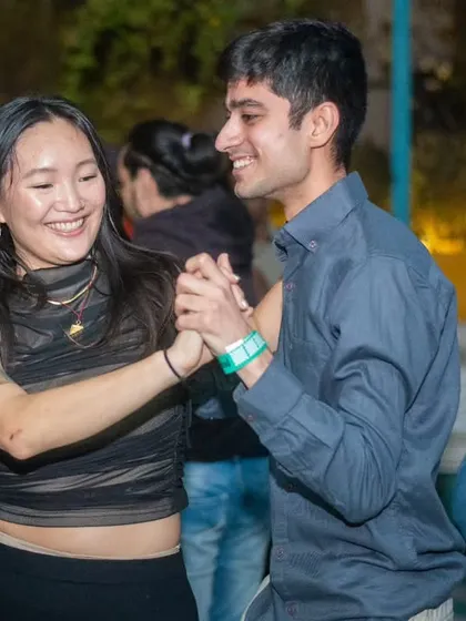 A smiling dancer enjoying the music and the company. The community vibe is everything.