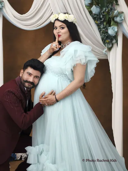 A playful and loving moment between the expecting parents. The dad-to-be leans in to listen to the belly, while the mom-to-be shares a little secret, making for a fun and memorable shot.