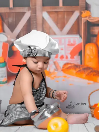 Lost in a world of culinary play. The detailed backdrop and props create an immersive environment for the baby, making every photo from the session unique.