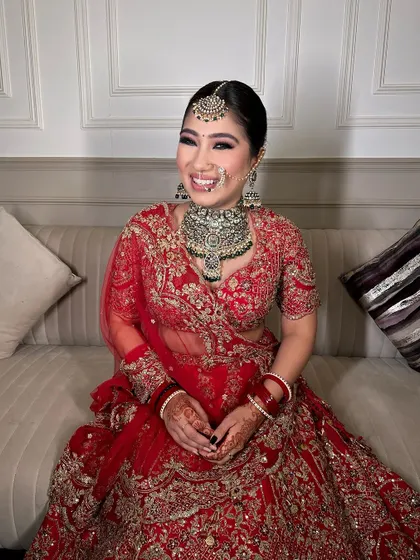 The joy on her face says it all. This bride chose a heavy polki set to complement her beautiful red lehenga.