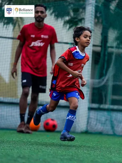 A young athlete sprints during a speed and agility drill. We focus on developing the physical attributes required to excel on the football pitch.