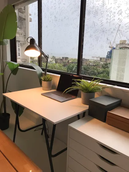 A slightly different angle of my desk setup. The plants and simple furniture create a calm and peaceful environment for me to work in.