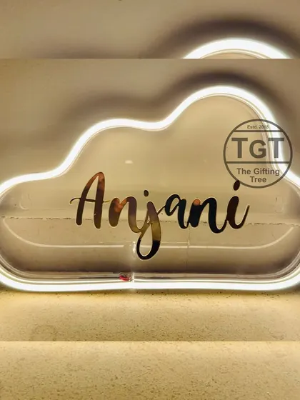 This is another example of my cloud-shaped neon sign in warm white, personalized with the name "Anjani."