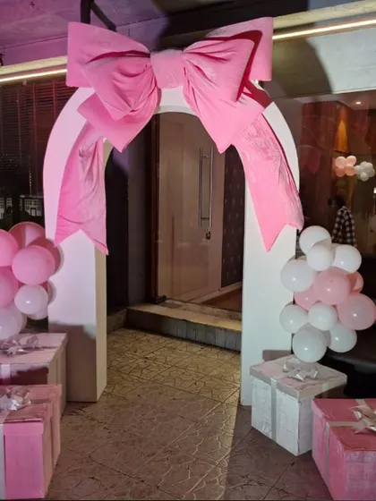 Another take on the bow trend. This time, a giant pink bow sits atop an archway, creating a picture-perfect entrance for a party.