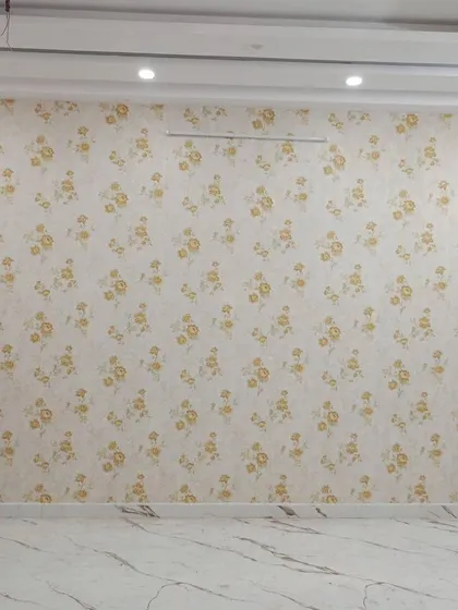 A full-room view of a simple yellow floral wallpaper.