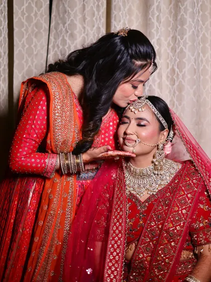A sweet moment between the bride and her sister.