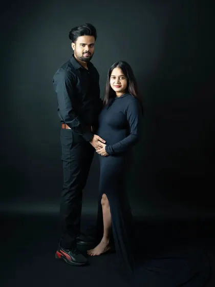 A simple and strong pose for an expecting couple. The dark, minimalist backdrop keeps the focus on their connection and the new life they've created together.