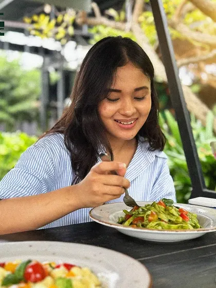 A smile of pure joy while enjoying a plate of our delicious pesto pasta. That's the GCBC effect.