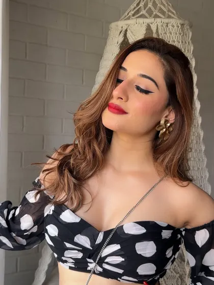 A close-up of the vintage-inspired look. The sharp winged liner and matte red lip are iconic for a reason.