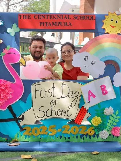 A happy family marking their child's first day of school. We believe a strong home-school connection is vital, and it all starts with these shared moments of joy.