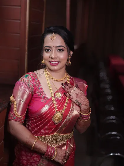 A close-up portrait of the bride. Her makeup features a classic red lip and defined eyes, a timeless look that never goes out of style.