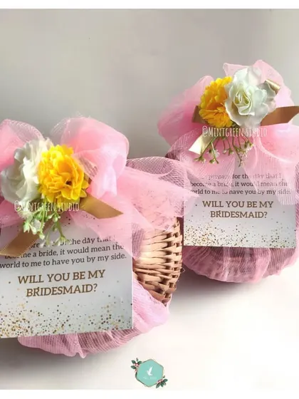 Two beautiful bridesmaid proposal baskets, wrapped and ready to go. Each one includes a personal note asking that all-important question.