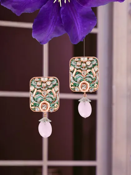 Diamonds, emeralds, and a blush of pink gemstones. These earrings are a reflection of her heart’s joy and timeless grace.