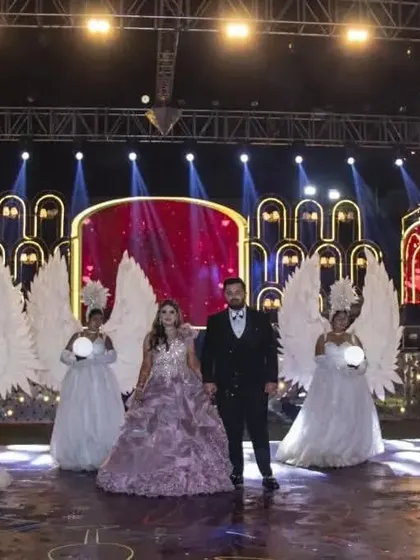 The stage comes alive with a grand couple entry. Dancers with angel wings and orbs flank the couple, complemented by the warm lighting and cold pyro effects of the sangeet stage I designed.