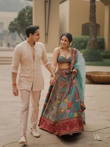 A candid walking shot of the couple. Shubhangi's makeup looks effortless and chic.