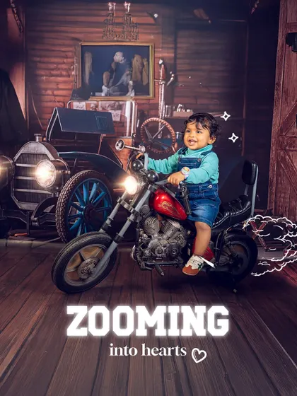 Zooming into hearts on a mini motorcycle. The vintage garage theme is perfect for capturing a child's adventurous spirit with cool props and dramatic lighting.