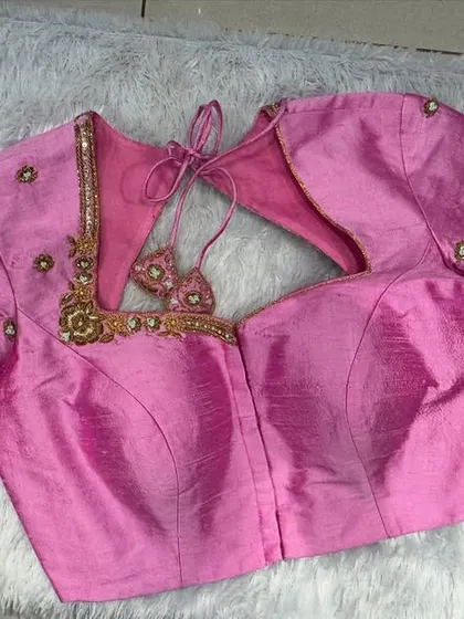 A pretty pink blouse with a sweetheart neckline and subtle zardosi handwork on the sleeves.