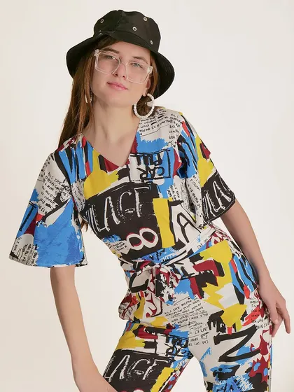 A three-quarter shot that shows the silhouette of the jumpsuit and its belted waist.